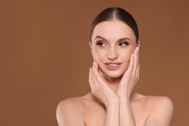 Photo of Portrait of beautiful young woman on beige background, space for text