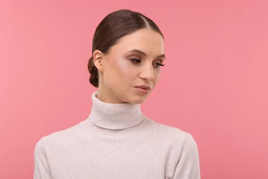 Photo of Portrait of beautiful young woman on pink background,