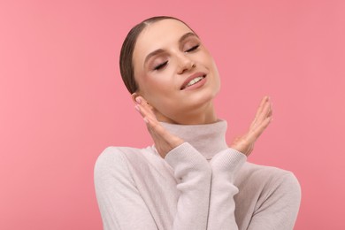 Photo of Portrait of beautiful young woman on pink background,