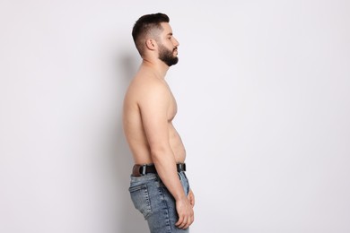 Photo of Man before scoliosis treatment on light background
