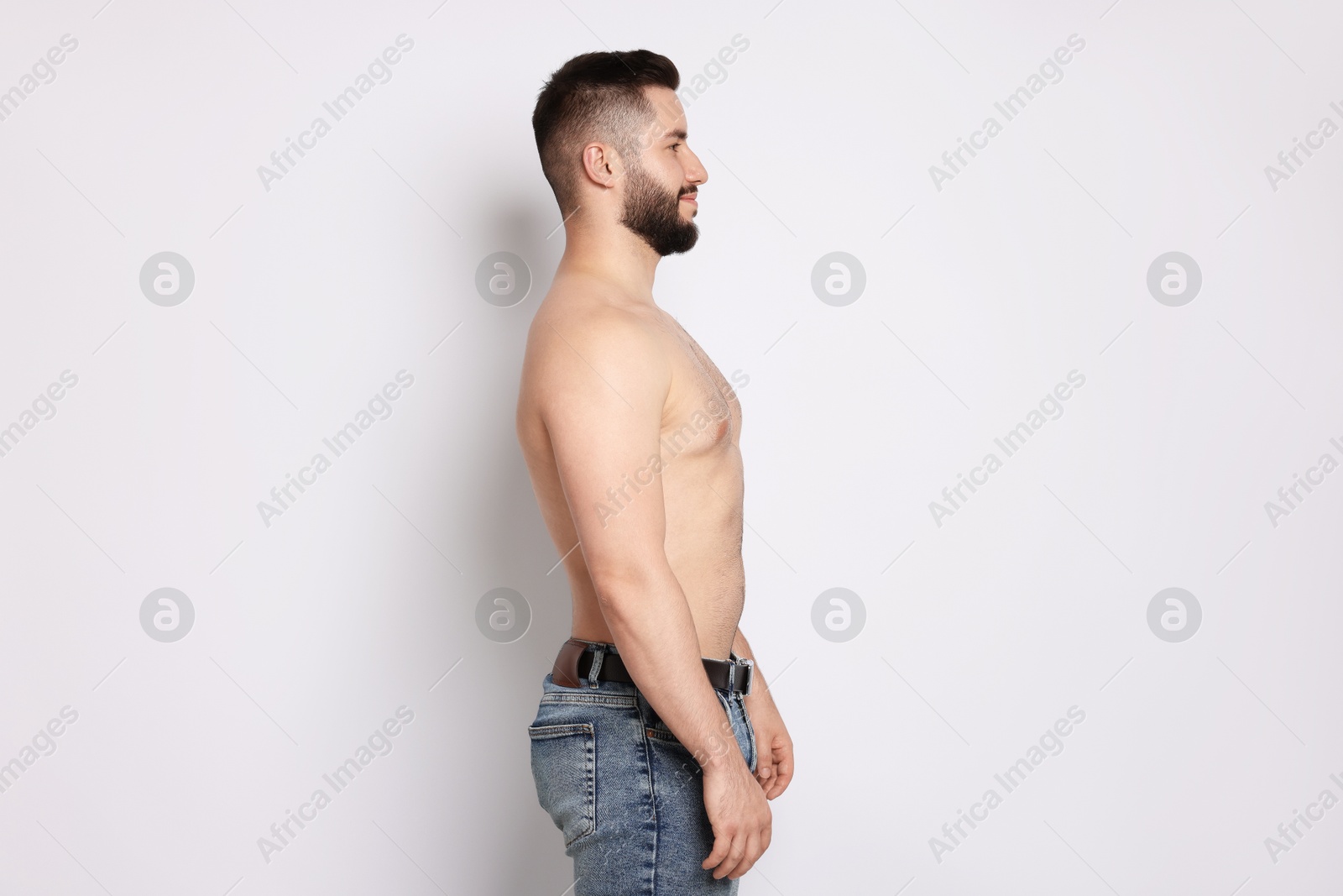 Man after weight loss on light background Photo of Man after weight loss on light background