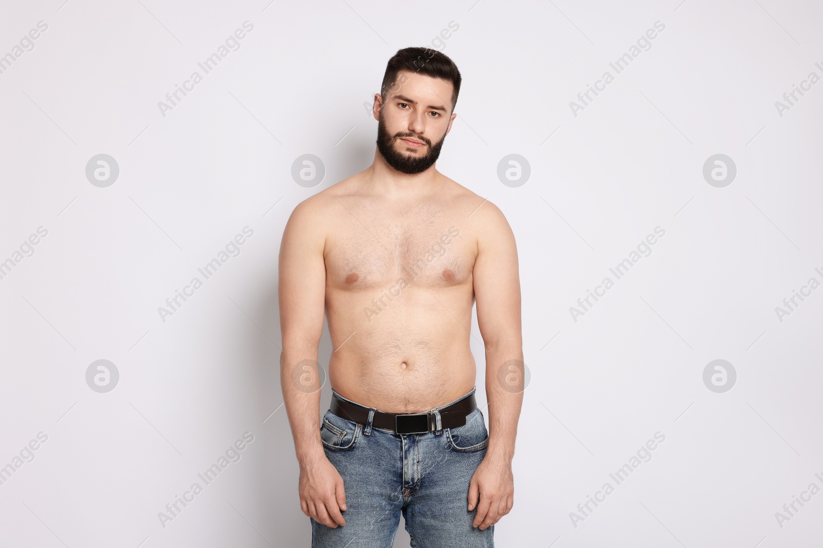 Man after weight loss on light background Photo of Man after weight loss on light background