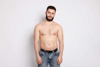 Photo of Man after weight loss on light background