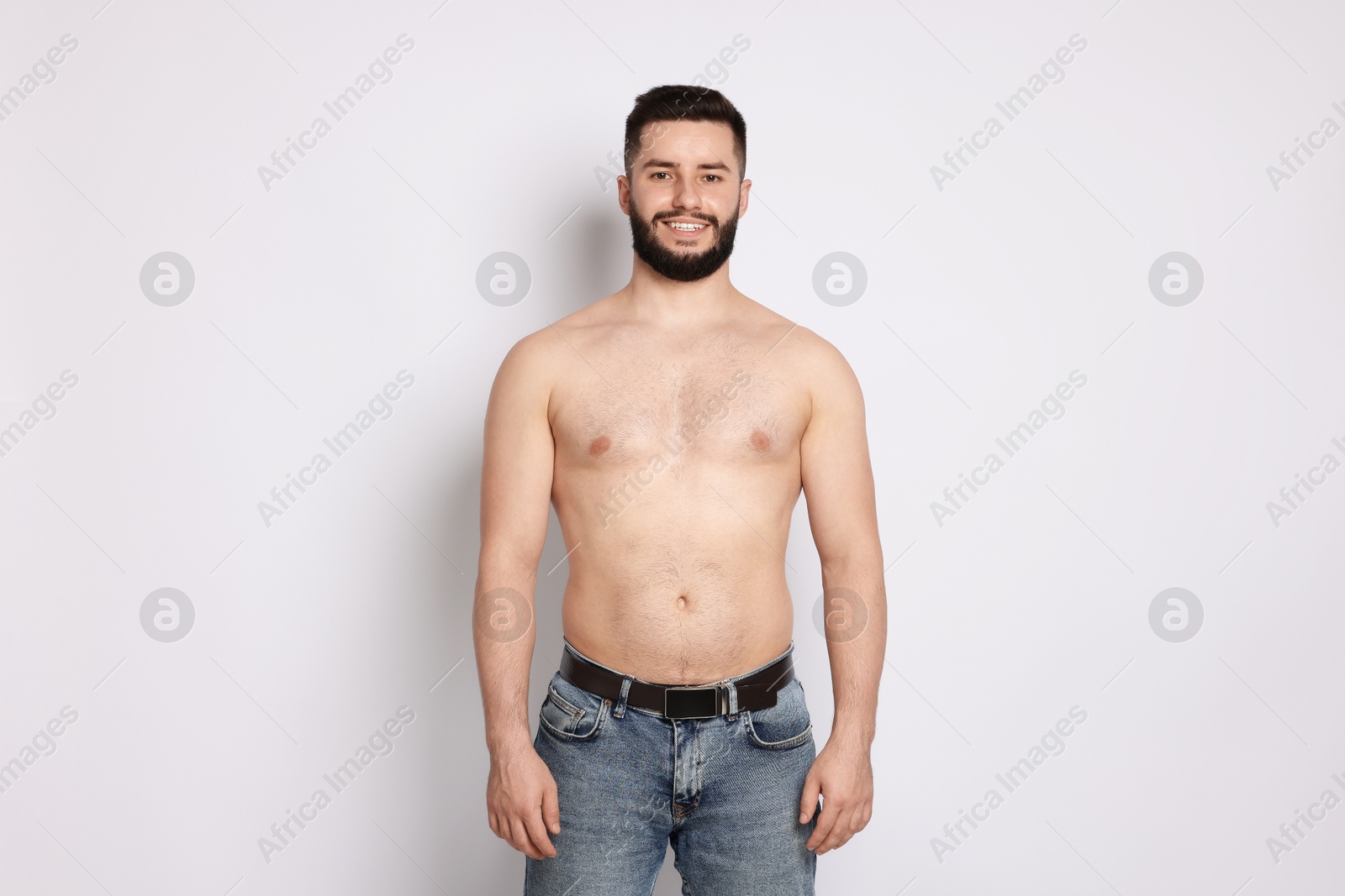 Man after weight loss on light background Photo of Man after weight loss on light background