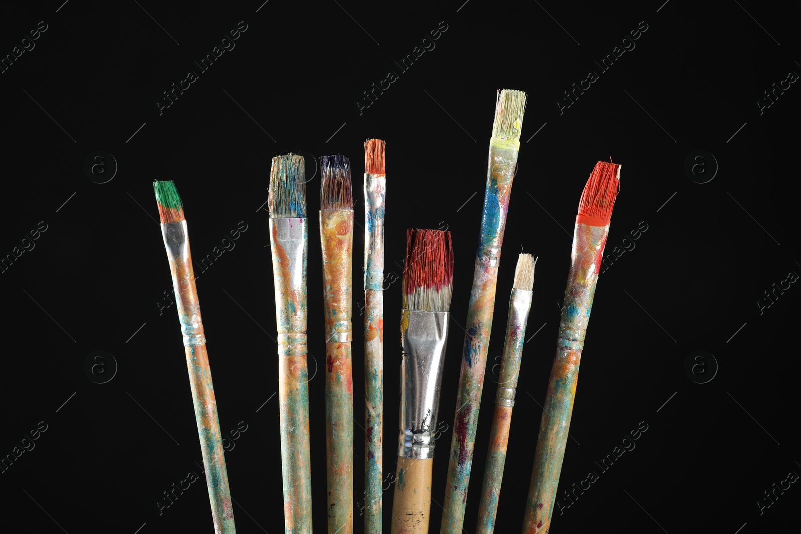 Many dirty paintbrushes on black background, closeup Photo of Many dirty paintbrushes on black background, closeup