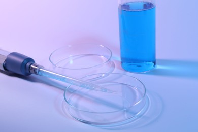 Photo of Petri dishes, micropipette and beaker with sample on light background