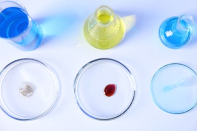 Photo of Petri dishes and flasks with samples on white background, flat lay