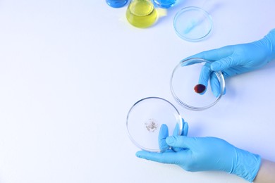 Photo of Scientist holding Petri dishes on white background, above view. Space for text