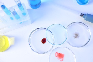 Photo of Petri dishes, flasks and test tubes with samples on white background, above view