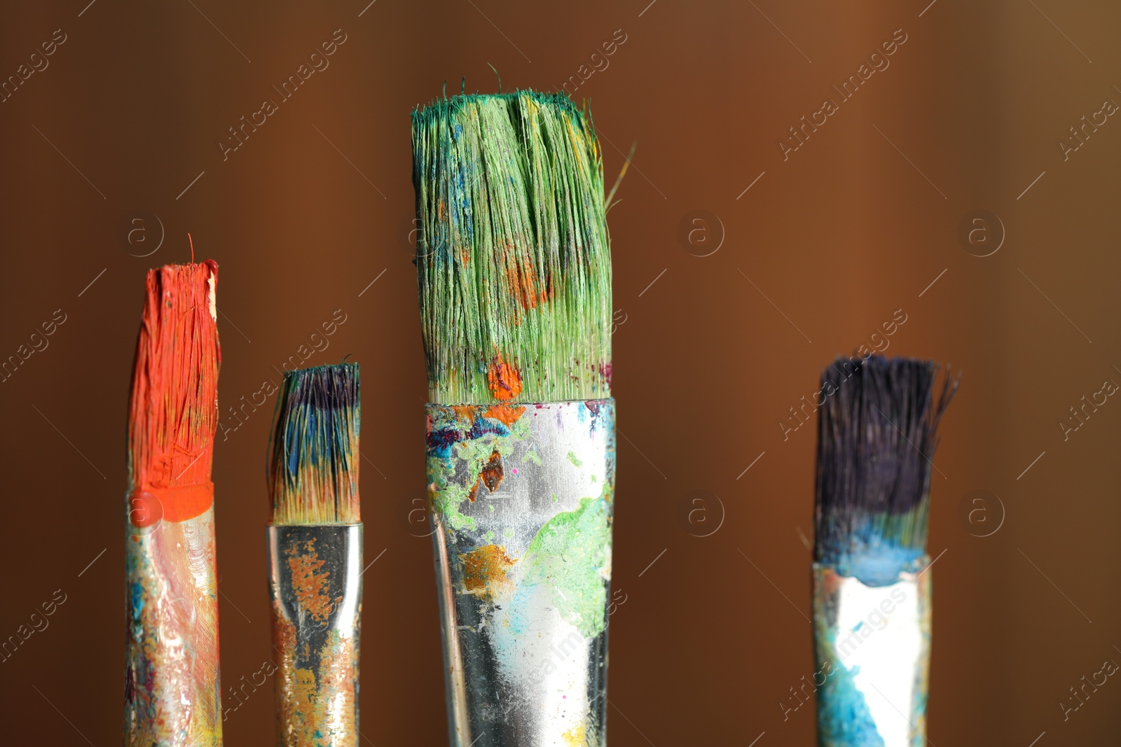 Many dirty paintbrushes on wooden background, closeup Photo of Many dirty paintbrushes on wooden background, closeup