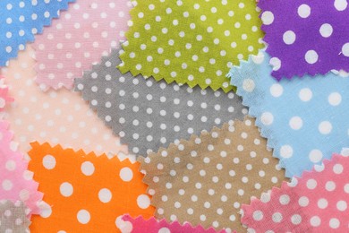 Photo of Samples of different fabrics as background, top view