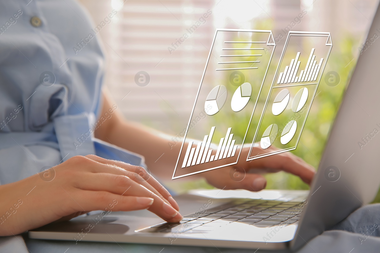 Woman using laptop at table, closeup. Virtual screen with documents above computer Image of Woman using laptop at table, closeup. Virtual screen with documents above computer