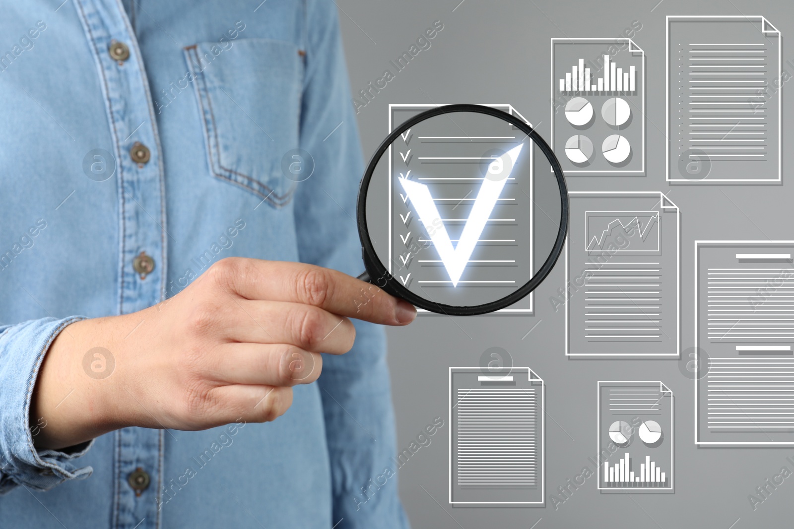 Woman holding magnifying glass over virtual approved document with check mark against grey background, closeup Image of Woman holding magnifying glass over virtual approved document with check mark against grey background, closeup