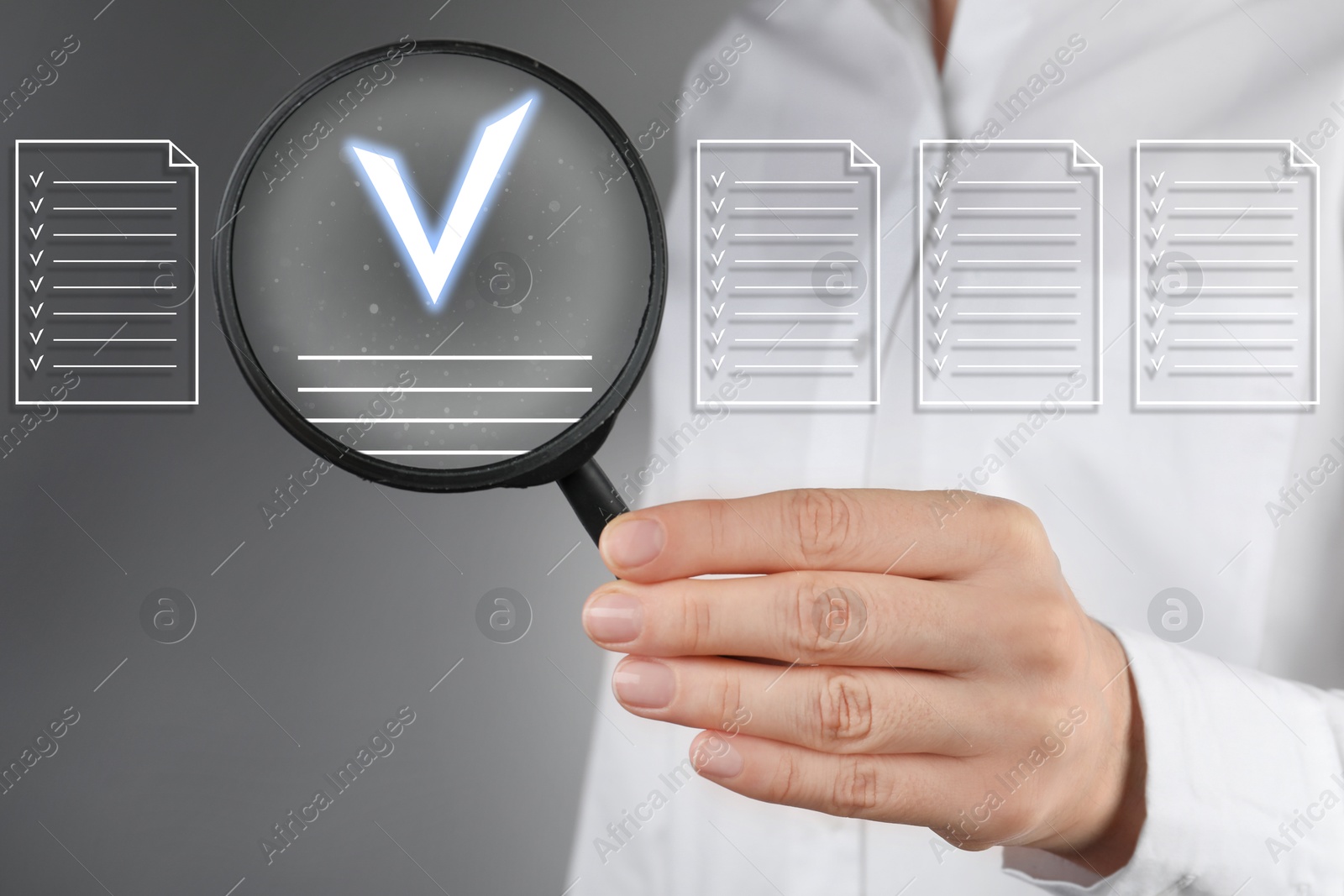 Approved documents on virtual screen. Woman holding magnifying glass with check mark inside against grey background, closeup. Image of Approved documents on virtual screen. Woman holding magnifying glass with check mark inside against grey background, closeup.