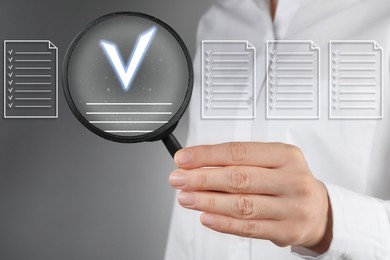 Image of Approved documents on virtual screen. Woman holding magnifying glass with check mark inside against grey background, closeup.