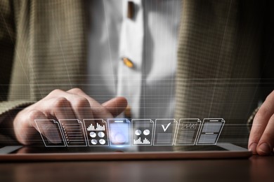 Image of Woman approving documents on virtual screen above tablet computer at table, closeup