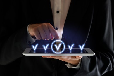 Image of Approved. Man touching check mark on virtual screen above tablet computer, closeup
