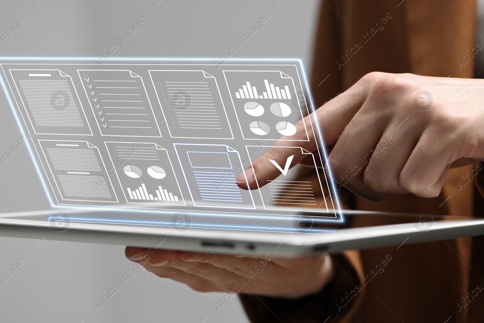 Woman approving documents on virtual screen above tablet computer indoors, closeup Image of Woman approving documents on virtual screen above tablet computer indoors, closeup