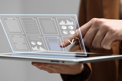 Image of Woman approving documents on virtual screen above tablet computer indoors, closeup