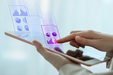 Image of Woman approving documents on virtual screen above tablet computer indoors, closeup