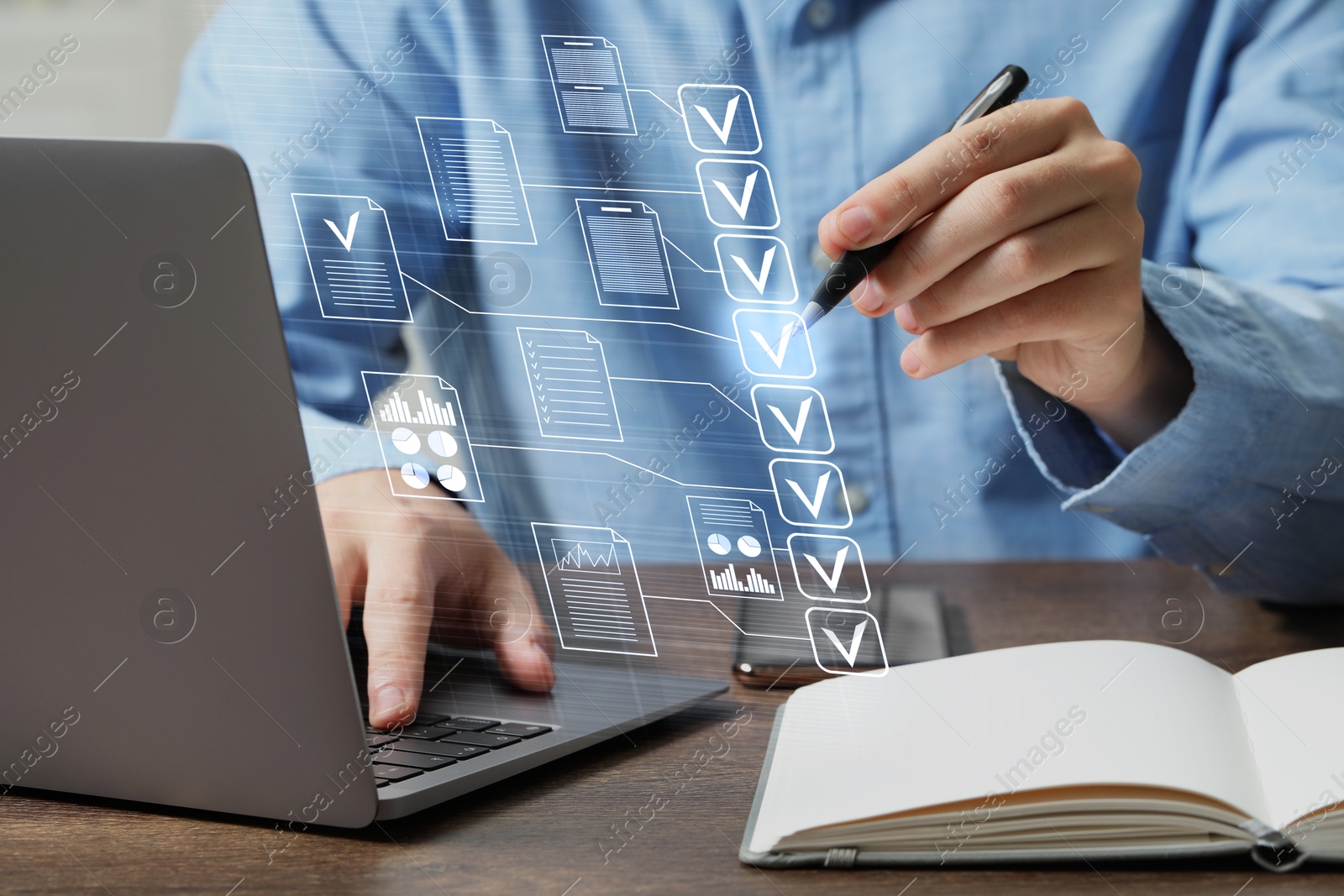 Man approving documents on virtual screen above laptop at table, closeup Image of Man approving documents on virtual screen above laptop at table, closeup
