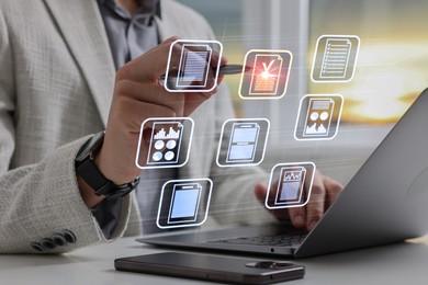Image of Man approving documents on virtual screen above laptop at table, closeup