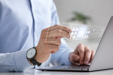 Image of Man approving documents on virtual screen above laptop at table, closeup