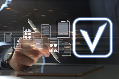 Image of Approved. Virtual screen with documents and check mark above tablet computer. Man using device at table, closeup