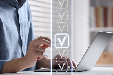 Image of Approved. Man touching check mark on virtual screen above laptop at table, closeup