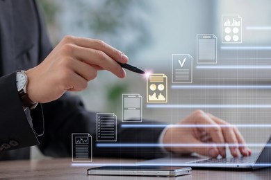 Image of Man approving documents on virtual screen above laptop at table, closeup