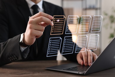 Image of Man approving documents on virtual screen above laptop at table, closeup