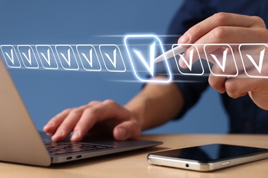 Image of Approved. Man touching check mark on virtual screen above laptop at table, closeup