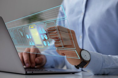 Image of Man approving documents on virtual screen above laptop at table, closeup