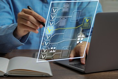Image of Man approving documents on virtual screen above laptop at table, closeup