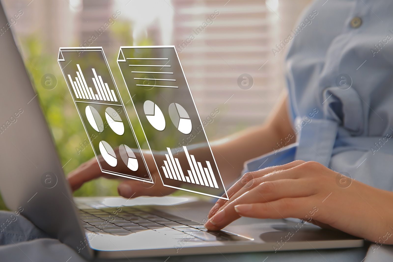 Woman using laptop at table, closeup. Virtual screen with documents above computer Image of Woman using laptop at table, closeup. Virtual screen with documents above computer