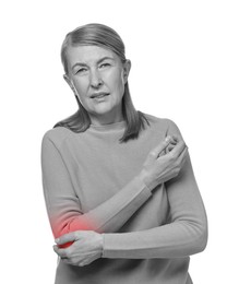 Image of Arthritis. Senior woman suffering from pain in elbow on white background. Black and white toning with red color accent