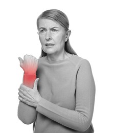 Image of Arthritis. Senior woman suffering from wrist pain on white background. Black and white toning with red color accent
