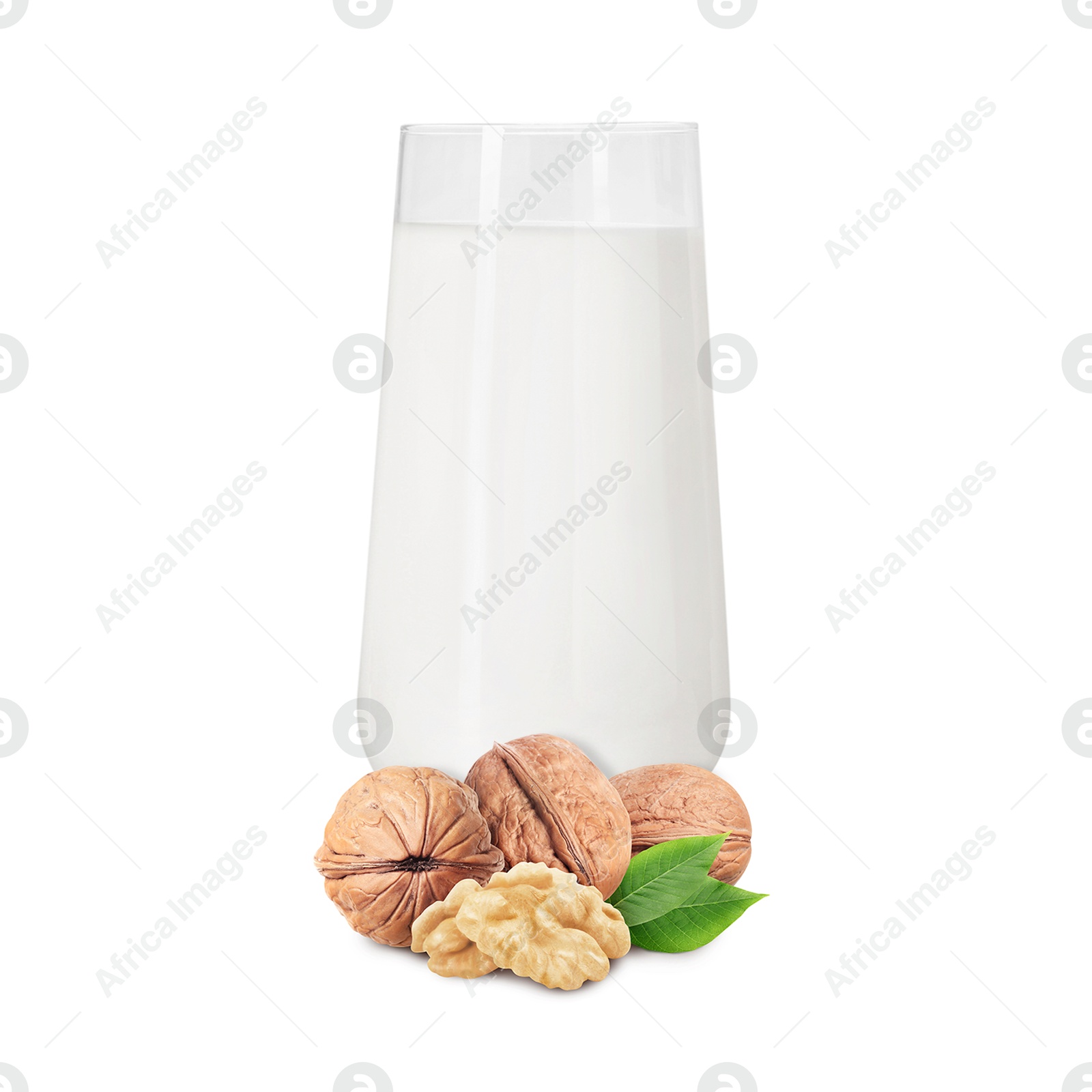 Nut milk in glass and walnuts isolated on white Image of Nut milk in glass and walnuts isolated on white