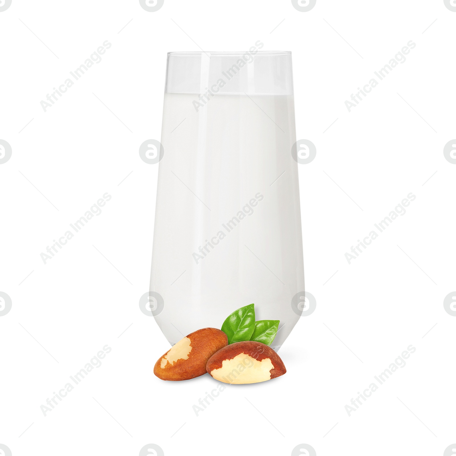 Nut milk in glass and Brazil nuts isolated on white Image of Nut milk in glass and Brazil nuts isolated on white
