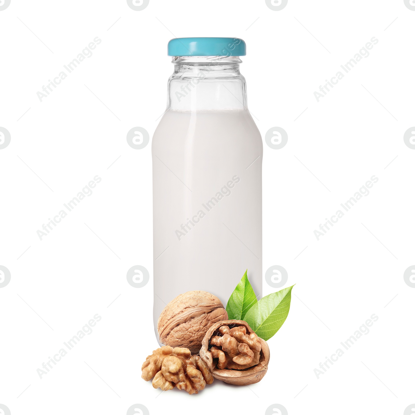 Nut milk in glass bottle and walnuts isolated on white Image of Nut milk in glass bottle and walnuts isolated on white