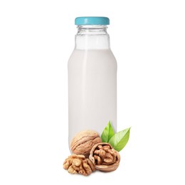 Image of Nut milk in glass bottle and walnuts isolated on white