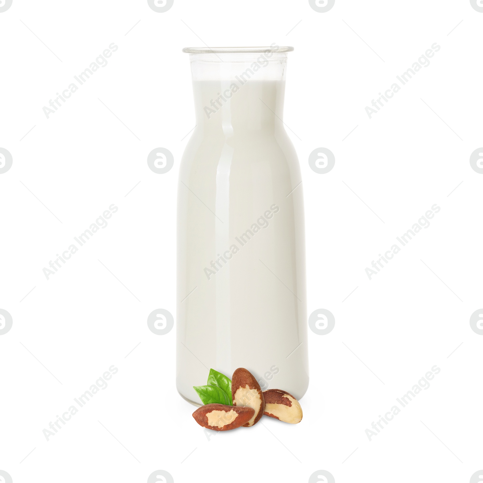 Nut milk in glass bottle and Brazil nuts isolated on white Image of Nut milk in glass bottle and Brazil nuts isolated on white