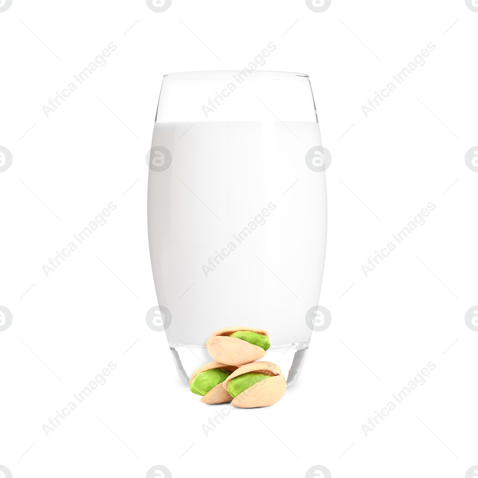 Nut milk in glass and pistachios isolated on white Image of Nut milk in glass and pistachios isolated on white
