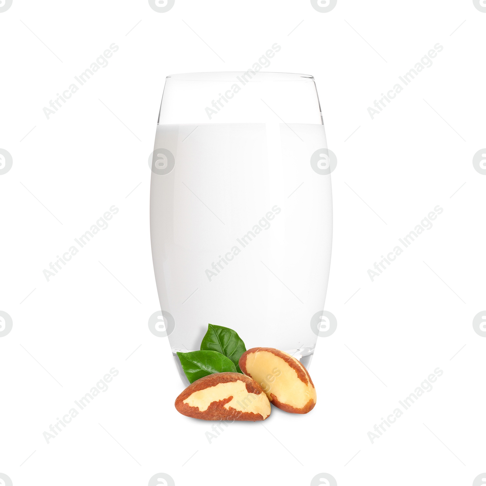 Nut milk in glass and Brazil nuts isolated on white Image of Nut milk in glass and Brazil nuts isolated on white
