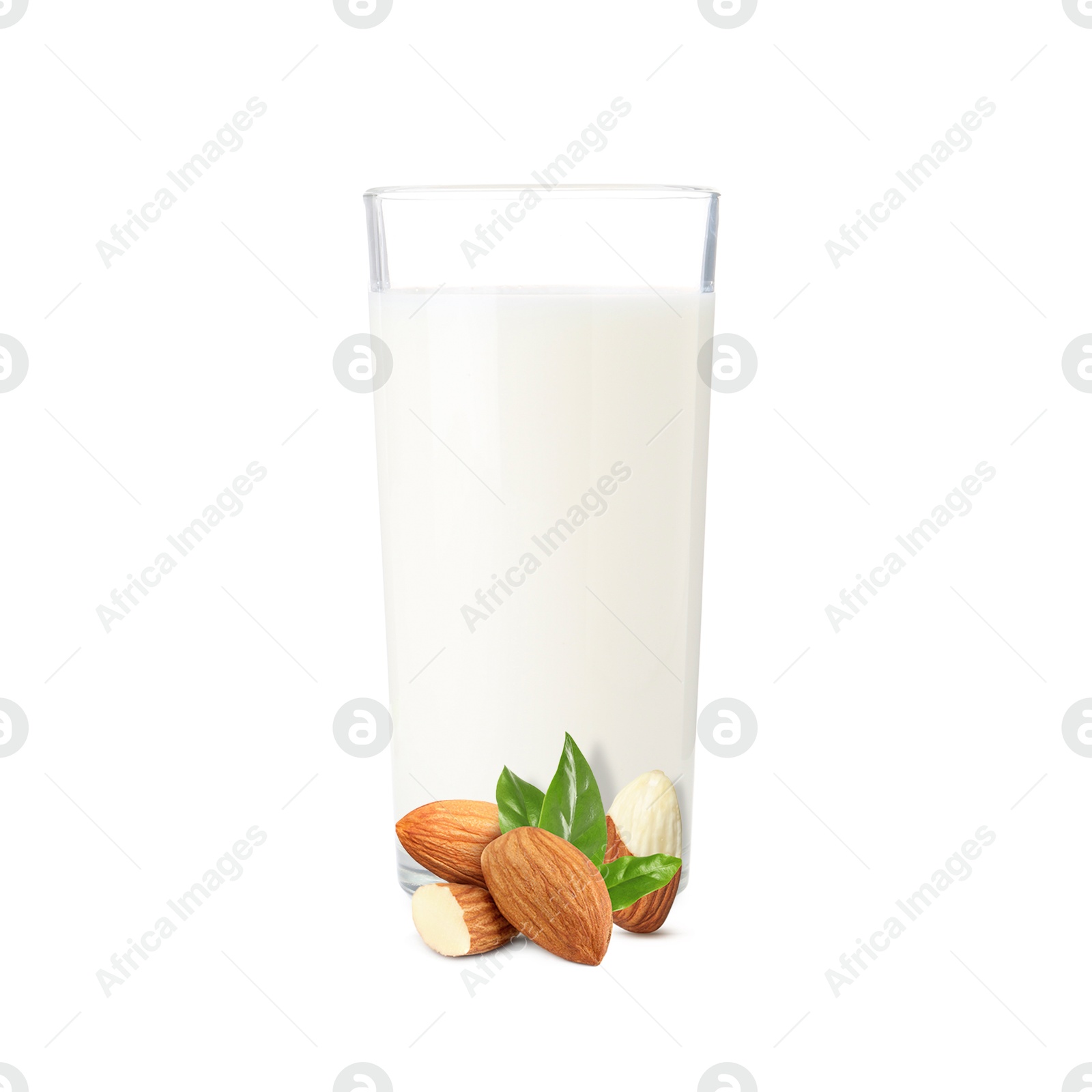 Nut milk in glass and almonds isolated on white Image of Nut milk in glass and almonds isolated on white