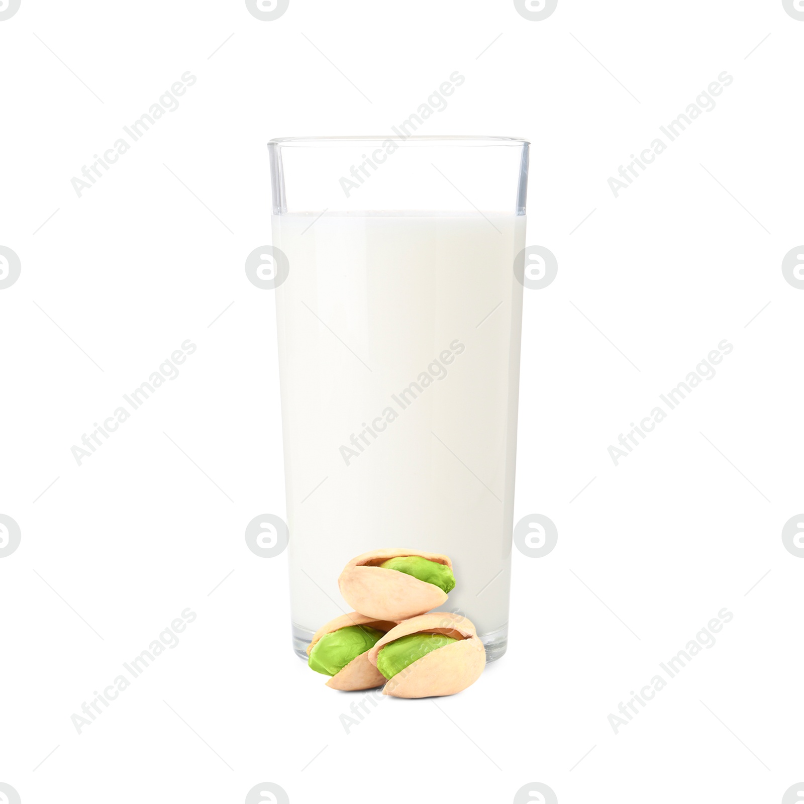 Nut milk in glass and pistachios isolated on white Image of Nut milk in glass and pistachios isolated on white