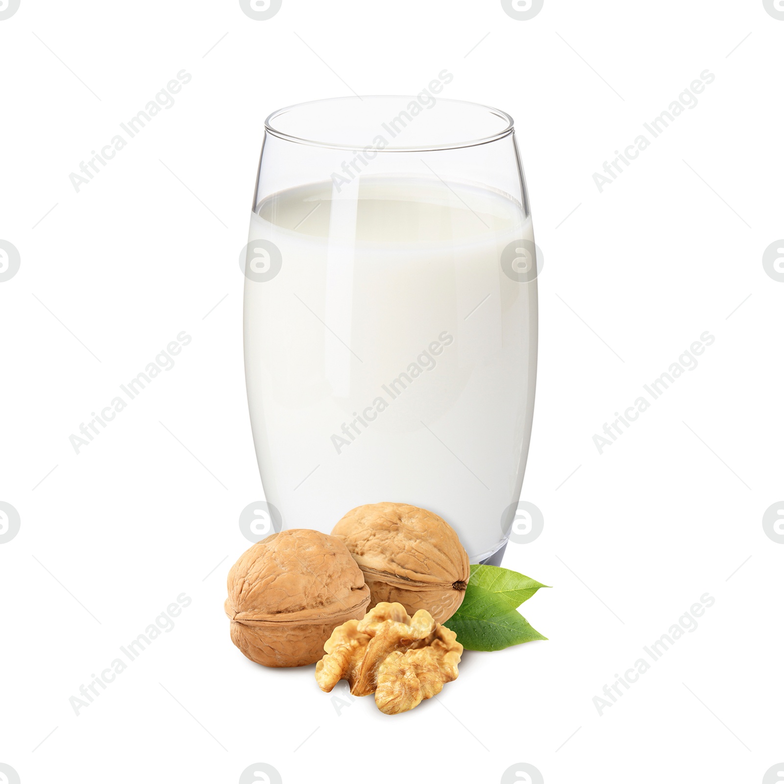 Nut milk in glass and walnuts isolated on white Image of Nut milk in glass and walnuts isolated on white