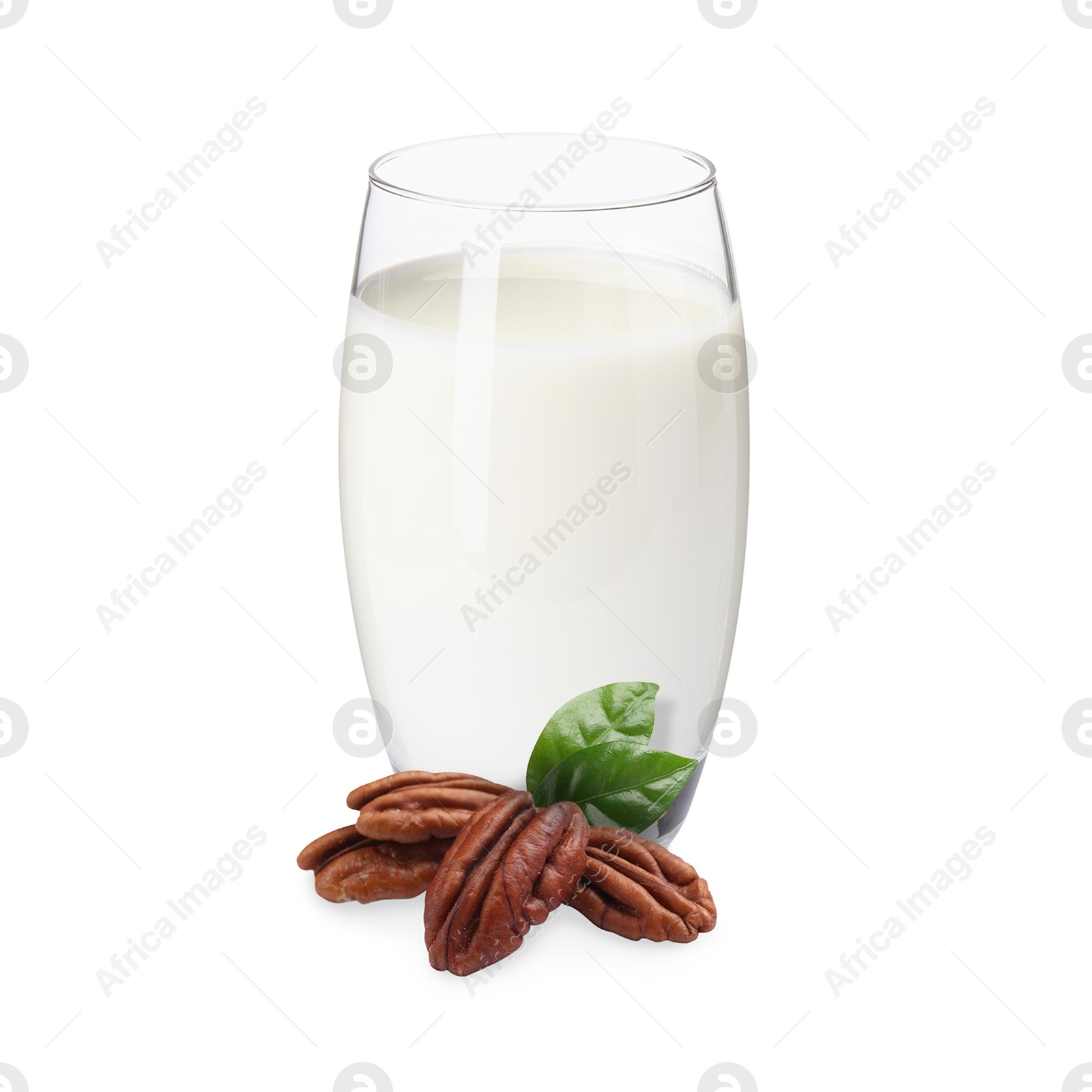 Nut milk in glass and pecans isolated on white Image of Nut milk in glass and pecans isolated on white