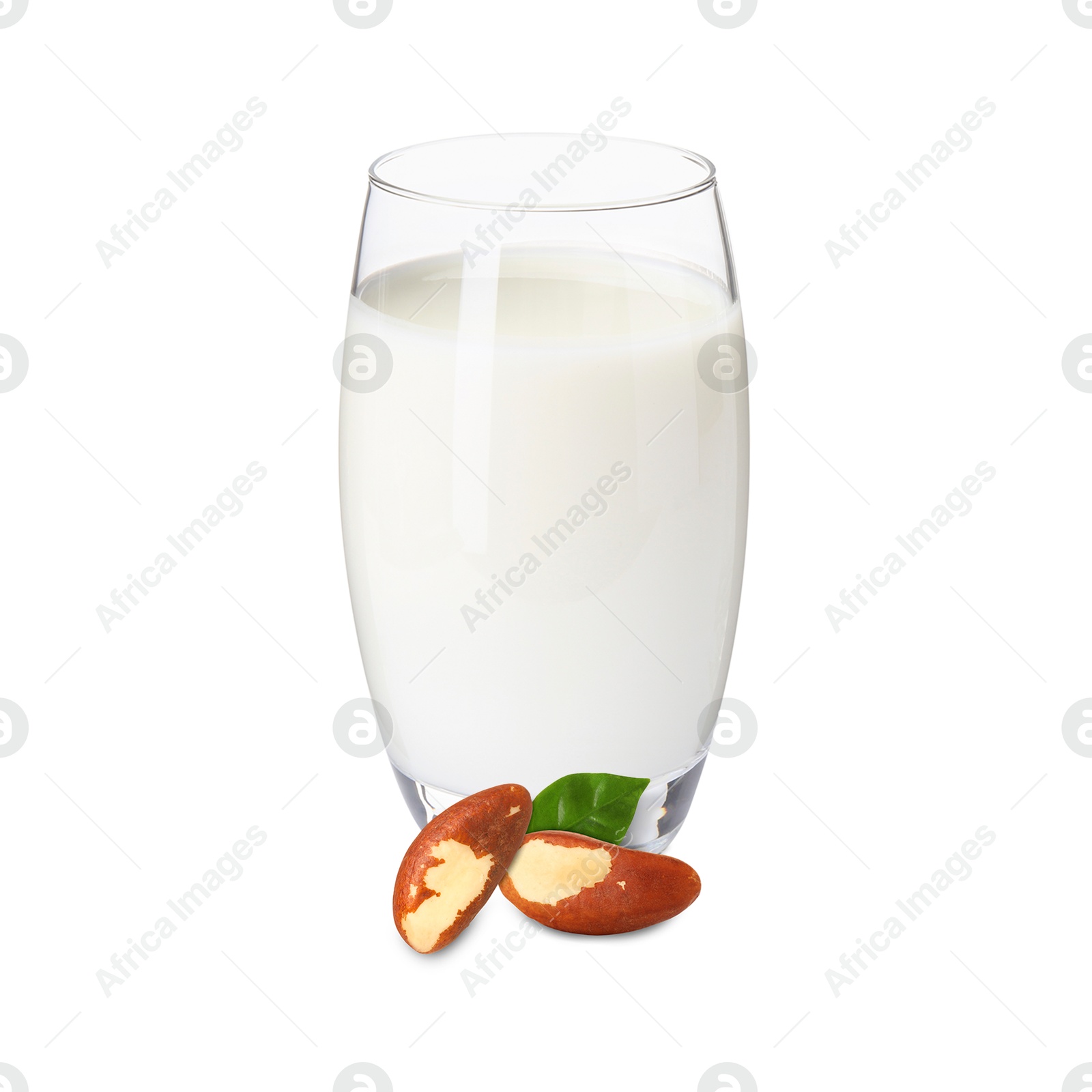 Nut milk in glass and Brazil nuts isolated on white Image of Nut milk in glass and Brazil nuts isolated on white