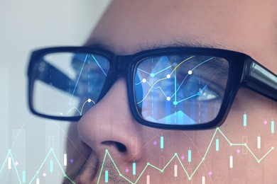Image of Stock exchange. Trader analyzing data, closeup. Graphs reflecting in his eyeglasses